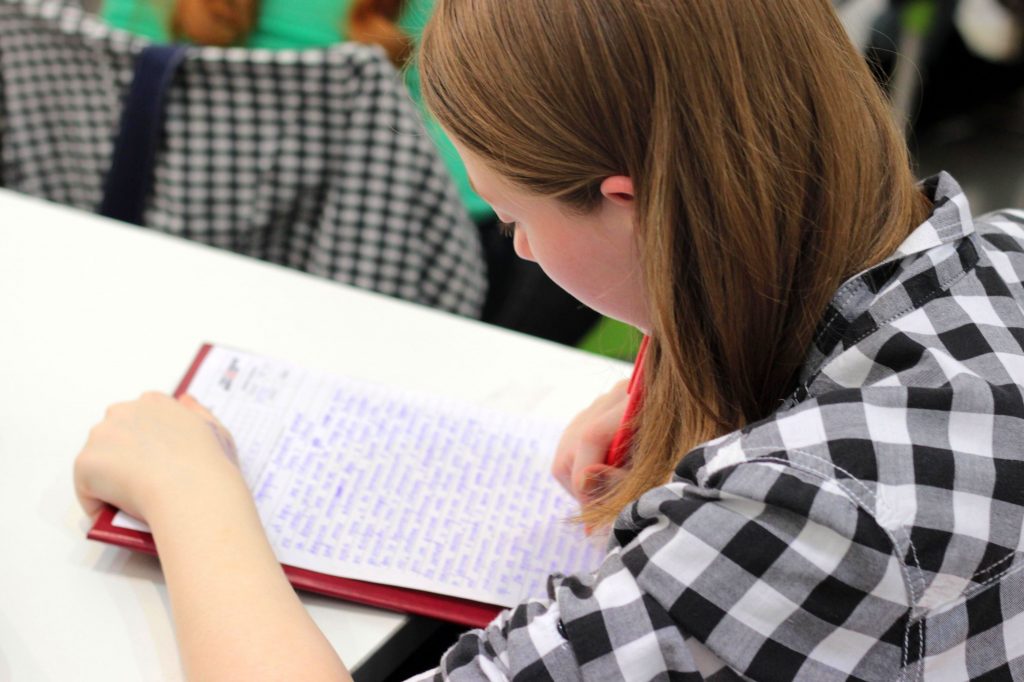 How to write a persuasive personal statement: girl revising her essay